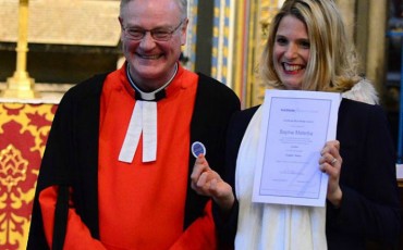 APTG prize winner Sophie Malaria raceiving her Blue Badge from the Reverend David Stanton, Canon of Westminster