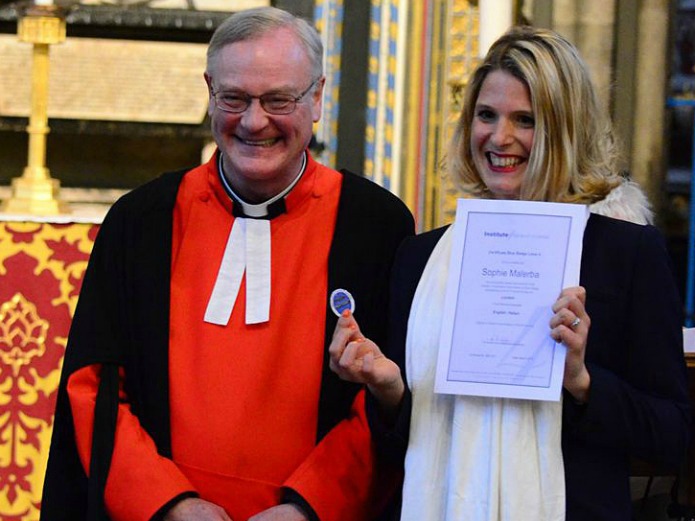 APTG prize winner Sophie Malaria raceiving her Blue Badge from the Reverend David Stanton, Canon of Westminster