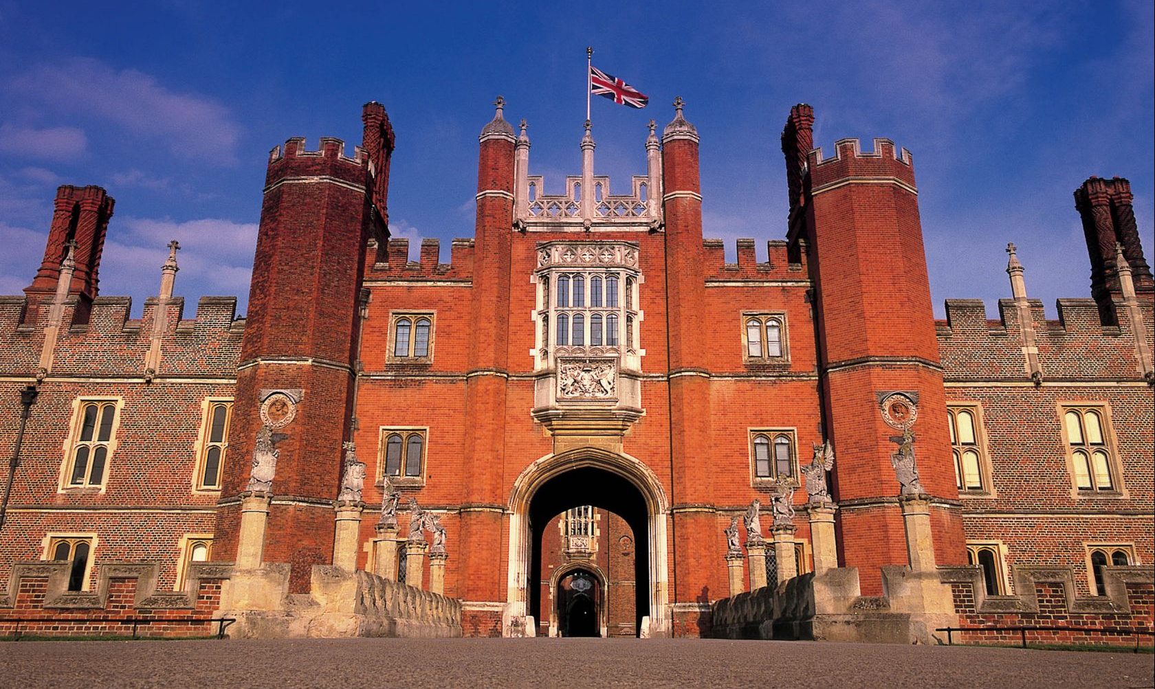 Hampton Court Palace - The bridge over the moat leads to the Tudor west front, which is protected by the King's Beasts.