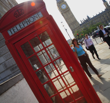 Palace of Westminster - Street scene in Westminster with a red telephone box and the Houses of Parliament in the background.
