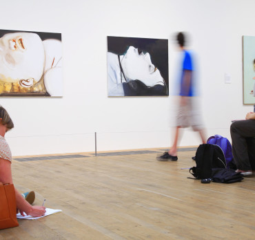 Visitors looking at paintings in the Tate Modern gallery, the national collection of modern and contemporary art housed in a former power station at Bankside, London.