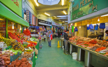 Brixton Market - assorted food for sale. Photo Credit: ©Visit London Images/Kool Runnings Ice Gold Green Boutique in Brixton. Photo Credit: ©Visit London Images/Pawel Libera.