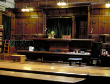 Legal London: London Royal Courts of Justice interior detail of building courtroom, wooden benches, judges chair and table. Photo Credit: ©Visit London Images.