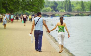London Royal Parks: Couple walking at the edge of The Serpentine in London's Hyde Park. Photo Credit: ©Visit London Images.