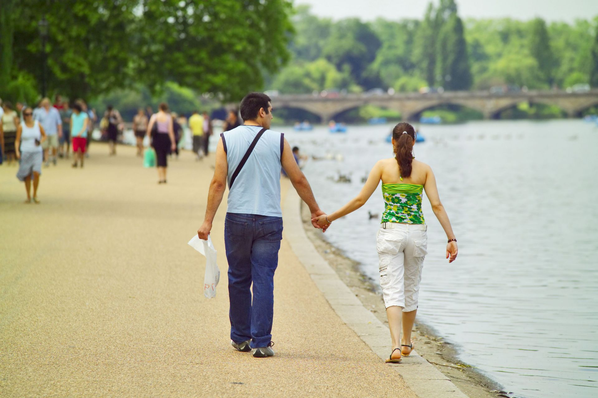 London Royal Parks: Couple walking at the edge of The Serpentine in London's Hyde Park. Photo Credit: ©Visit London Images.