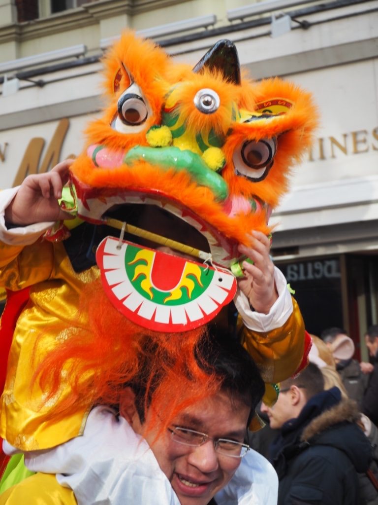 London Chinatown - little girl on her dad's shoulder at Chinese New Year Parade. Photo Credit: © Ursula Petula Barzey.