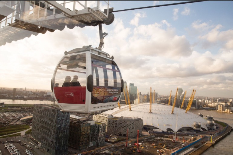 View of Emirates Air Line cabin with O2 in background. Photo Credit: © Emirates Air Line. 