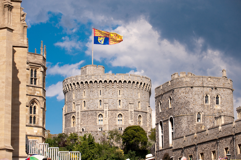 Windsor Castle: The Royal Standard flies at Windsor Castle. Photo Credit: © Visit England/Doug Harding.