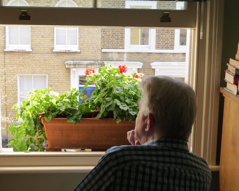 Steve looking out the window on Chisenhale Road, Bow, East London. Photo Credit: © Steve Fallon.