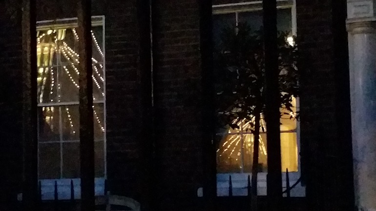 The Albert Bridge is reflected in the window of a house in Cheyne Walk, both George Elliot and Bram Stoker lived in the street at one time. Photo Credit: ©  Clarissa Skinner.