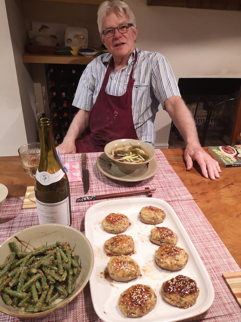 Steve with home-cooked miso soup, sesame green beans and chicken balls with lotus root dishes, Bow, East London. Photo Credit: © Steve Fallon.