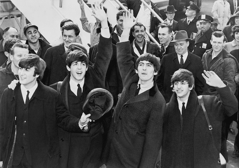 The Beatles arriving at John F. Kennedy International Airport, 7 February 1964. Public Domain via Wikimedia Commons.