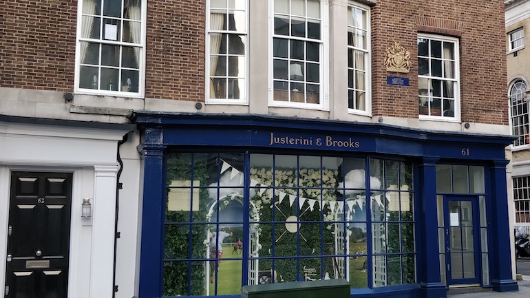 Gold-coloured coat of arms above the entrance to wine and spirit merchant, Justerini & Brooks. Photo Credit: © Mark King. 