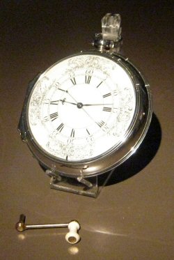 Harrison's sea watch No.1 (H4), with winding crank. Photo Credit: © Phantom Photographer via Wikimedia Commons.