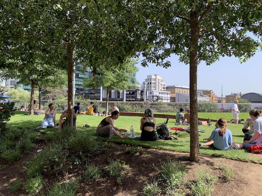 People relaxing next to the Regent’s Canal, outside Queer Britain. Photo Credit: © Ric Morris.