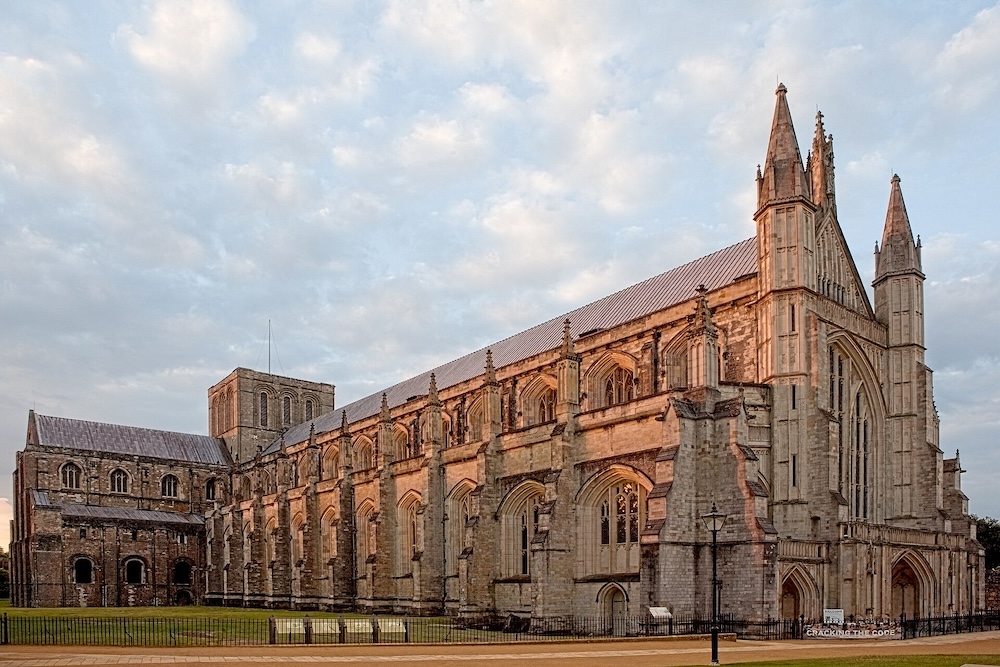 4am shot of Winchester Cathedral showing west end, central tower & UKs 2nd longest cathedral nave. Photo Credit: © WyrdLight.com via Wikimedia Commons.